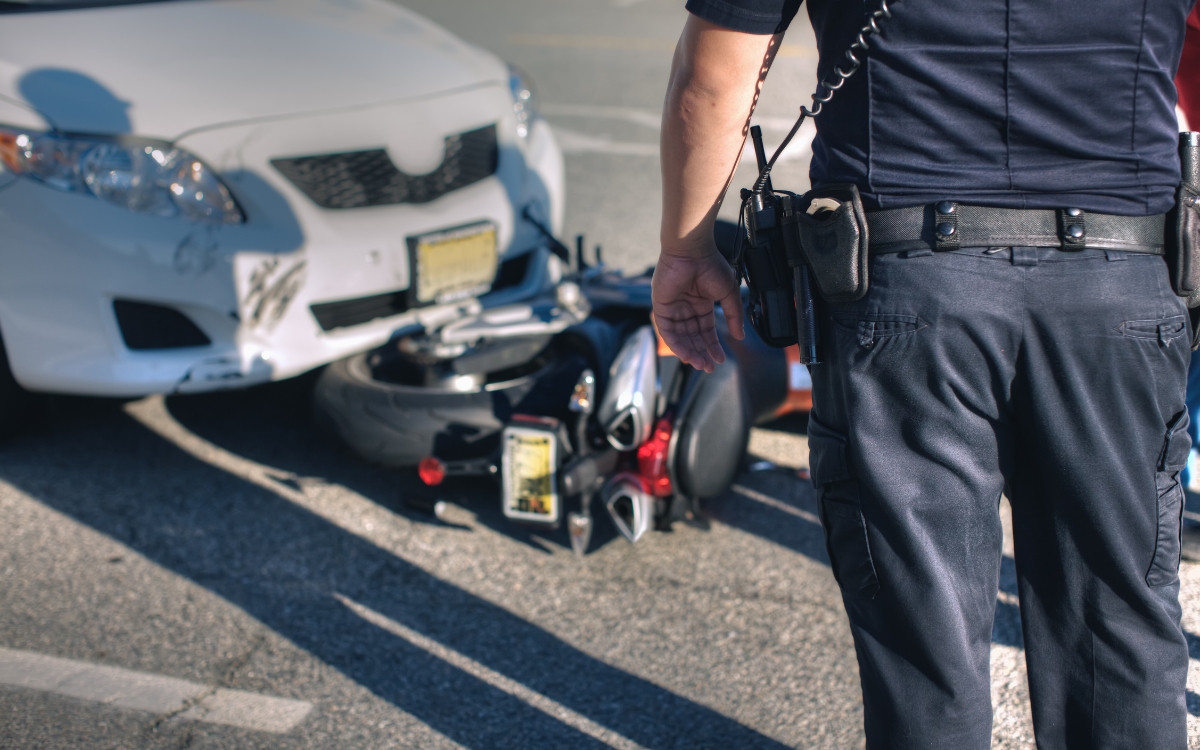 Traffic officer at car and motorcycle accident scene.